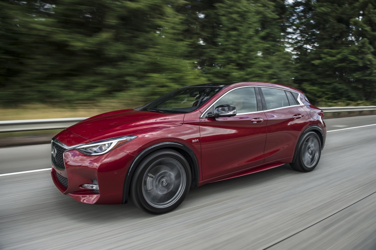 Driving 2019 Infiniti QX30S in Magnetic Red from a front left three-quarter view